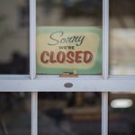 "Sorry we're Closed" vintage sign in a paned window of a vacation home in Ocean County
